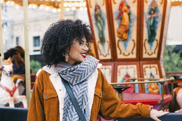 Young woman by carousel