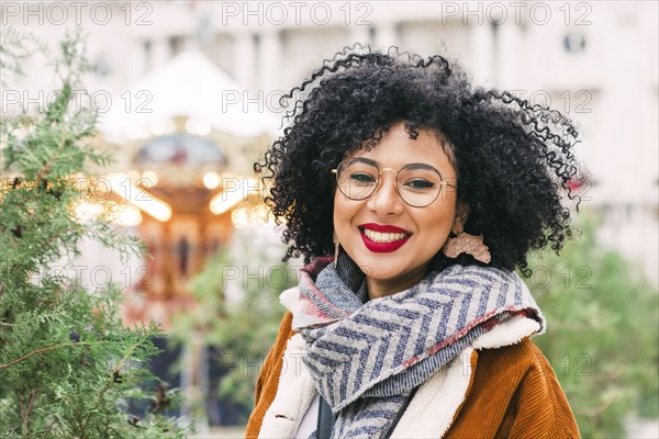 Portrait of smiling young woman wearing glasses and red lipstick