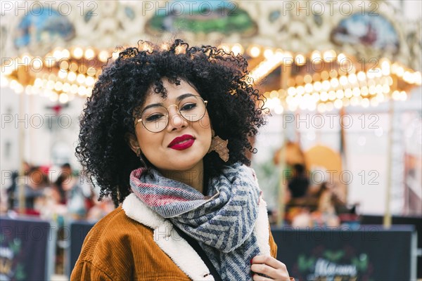 Portrait of young woman wearing glasses and red lipstick