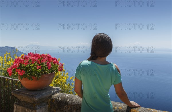 Rear view of woman by flower pot