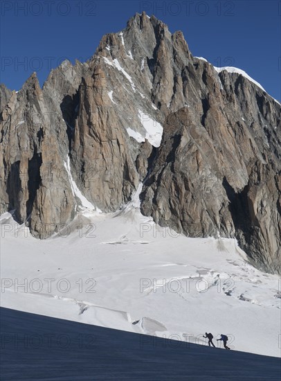 Silhouettes of hikers on Mer de Glace in Mont Blanc massif, France