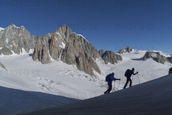 Silhouettes of hikers on Mer de Glace in Mont Blanc massif, France