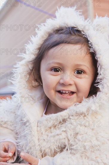 Portrait of smiling girl wearing white fur hood