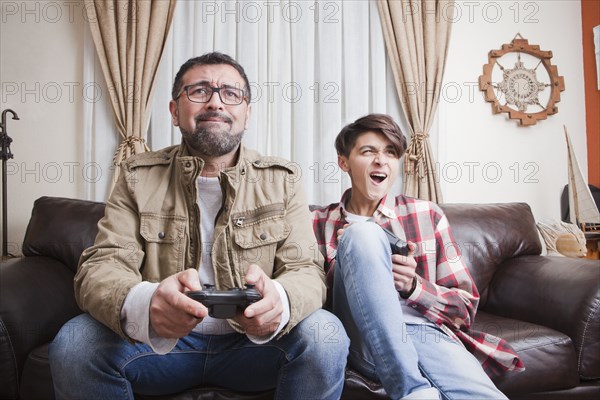 Father and son playing video game