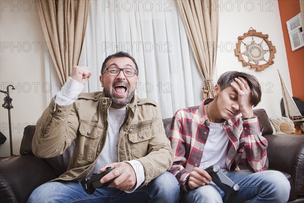 Father and son playing video game