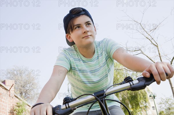 Teenage boy cycling in park