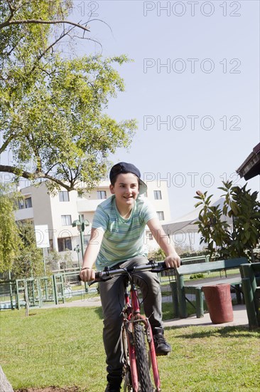 Teenage boy cycling in park