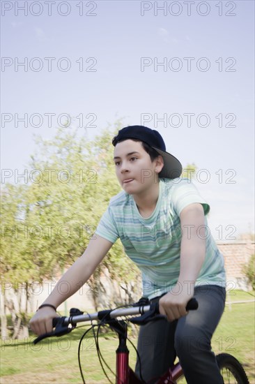 Teenage boy cycling in park