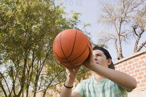 Teenage boy holding basketball