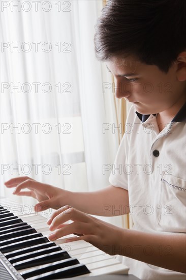 Teenage boy playing piano