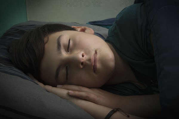 Boy sleeping in bed