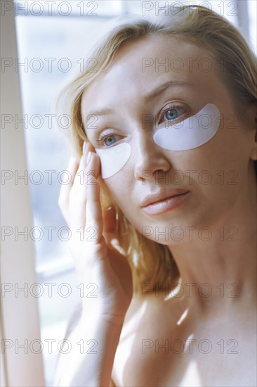 Woman applying under-eye mask