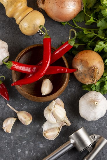 Chili peppers with garlic, onion and pepper mill