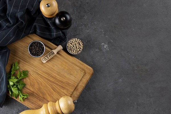 Pepper and pepper mills on cutting board