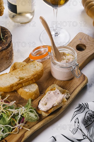 Toast and jar of spread on cutting board