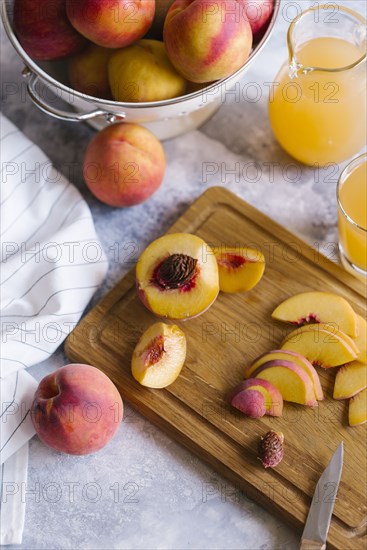 Peaches sliced on wooden cutting board