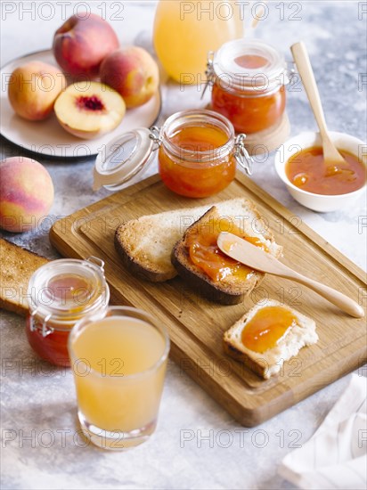 Apricot jam on toast with peaches and juice