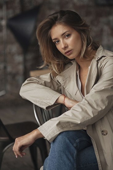 Young woman wearing grey trench coat