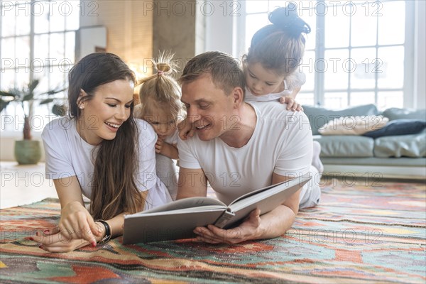 Parents and daughters reading picture book