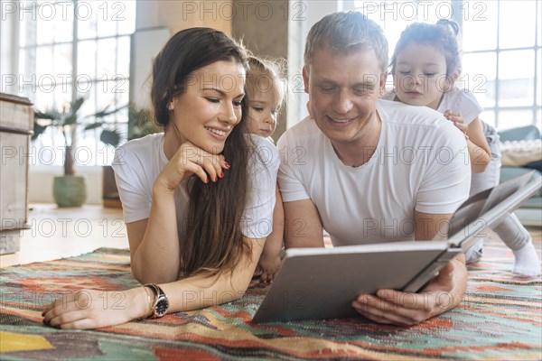 Parents and daughters reading picture book