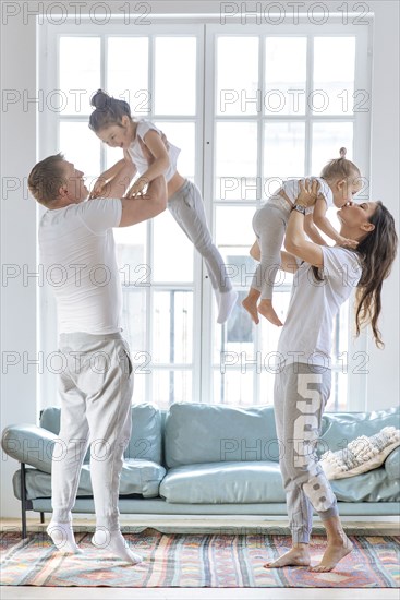 Parent lifting daughters by window