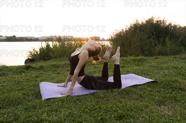 Young woman practicing yoga in park