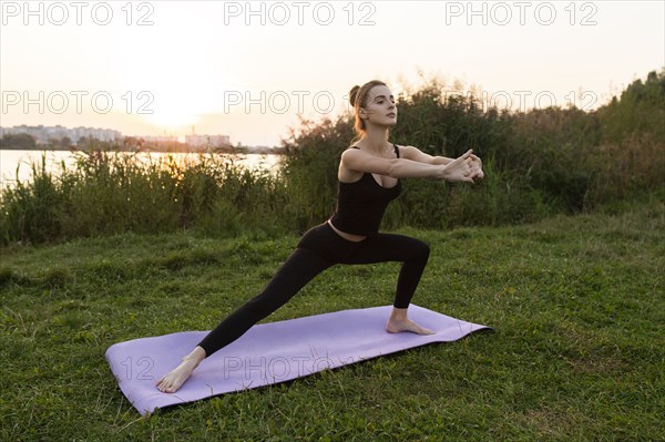 Young woman practicing yoga in park