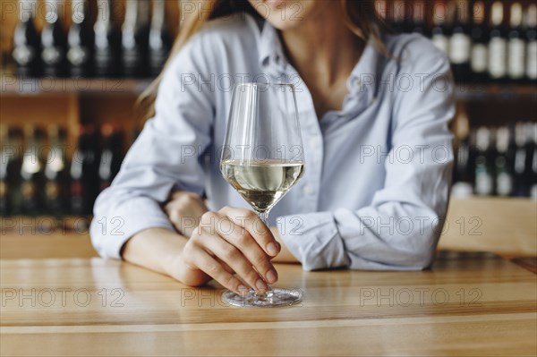 Woman holding glass of white wine