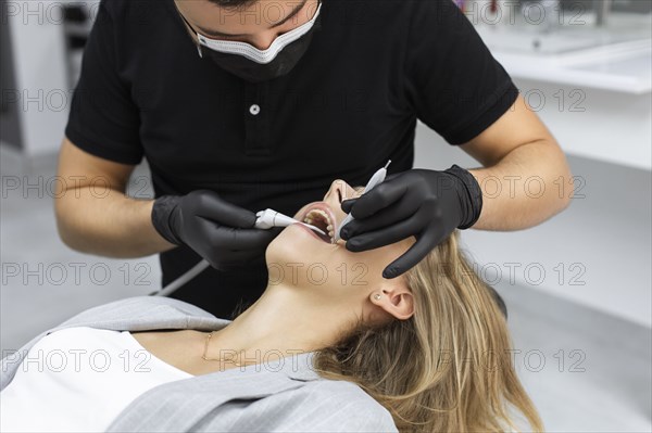 Dentist examining patient