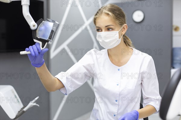 Dental assistant holding light