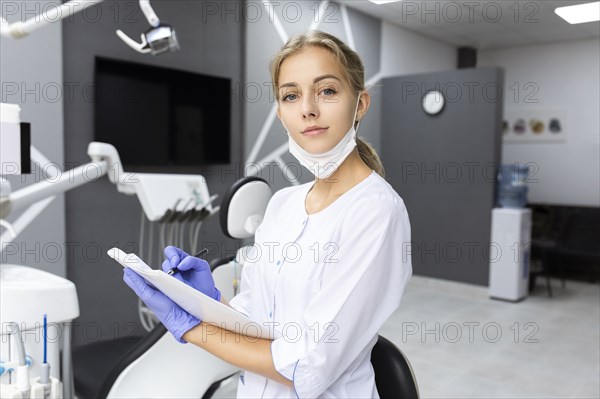 Dental assistant writing notes