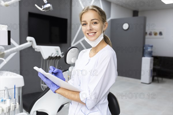 Dental assistant writing notes