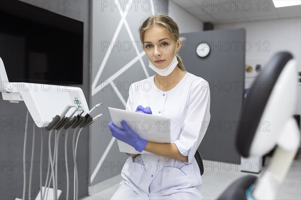 Dental assistant writing notes