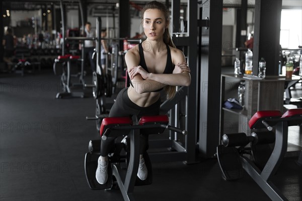 Young woman doing reverse sit-ups in gym