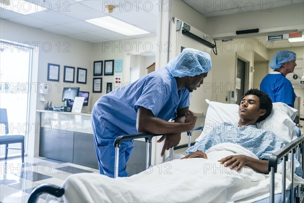 Nurse talking to teenage patient