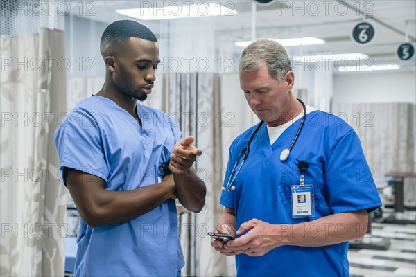 Doctor and nurse using smart phone in hospital