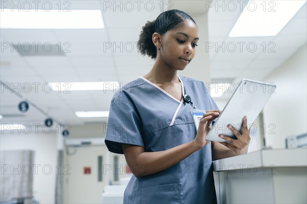 Nurse using digital tablet in hospital