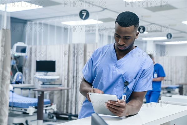 Nurse using digital tablet in hospital