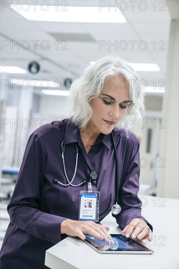 Doctor using digital tablet in hospital