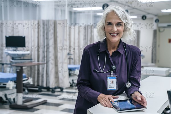 Smiling doctor holding digital tablet in hospital