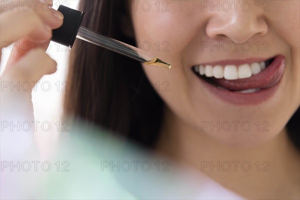 Woman with pipette of essential oil