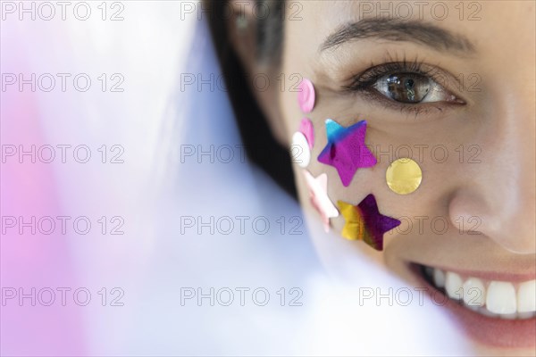 Woman with confetti on cheek