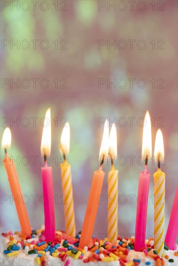 Lit candles on birthday cake