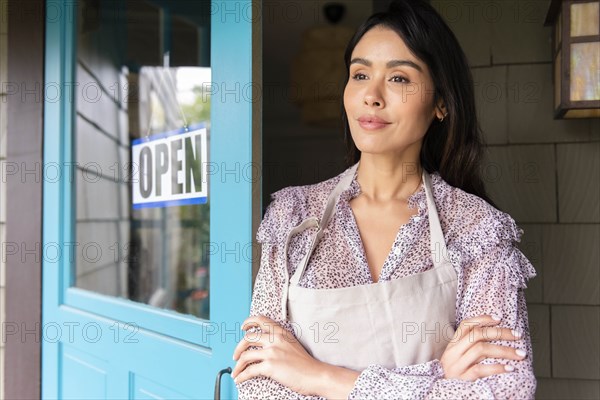 Woman by door to shop with open sign