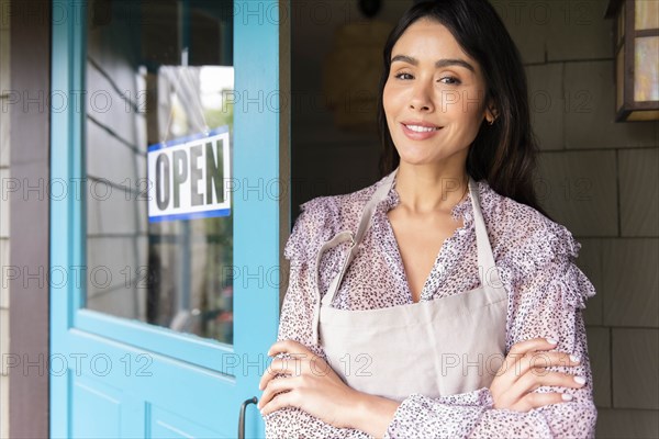 Woman by door to shop with open sign