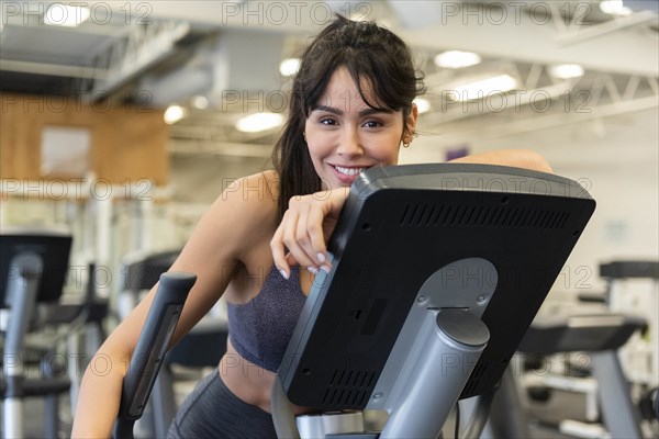 Smiling woman on elliptical machine