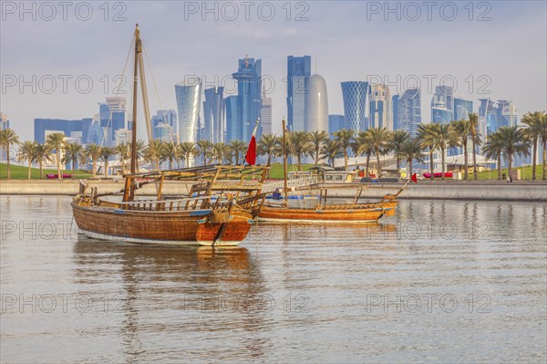 Boats by skyscraper skyline in Doha, Qatar