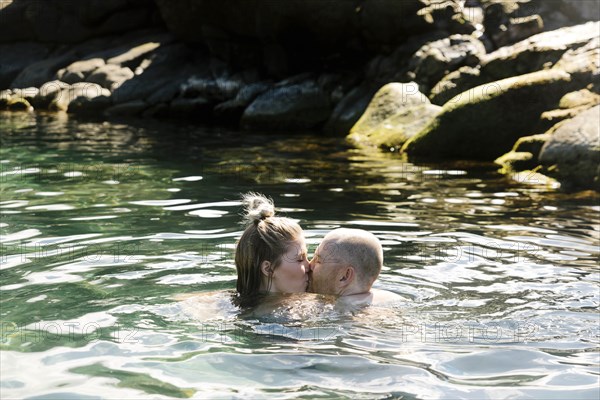 Couple kiss while swimming in sea