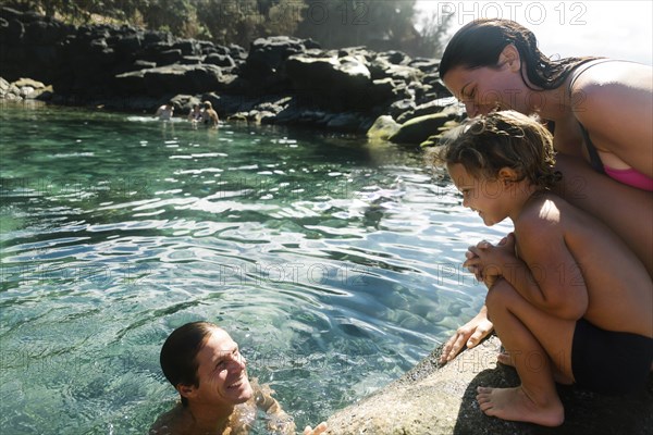 Boy with his parents by tide pool