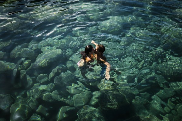 Couple kiss while swimming in sea